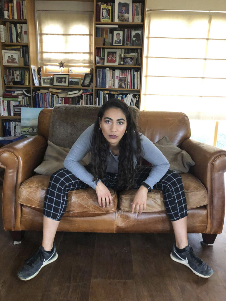 Woman manspreading on a sofa