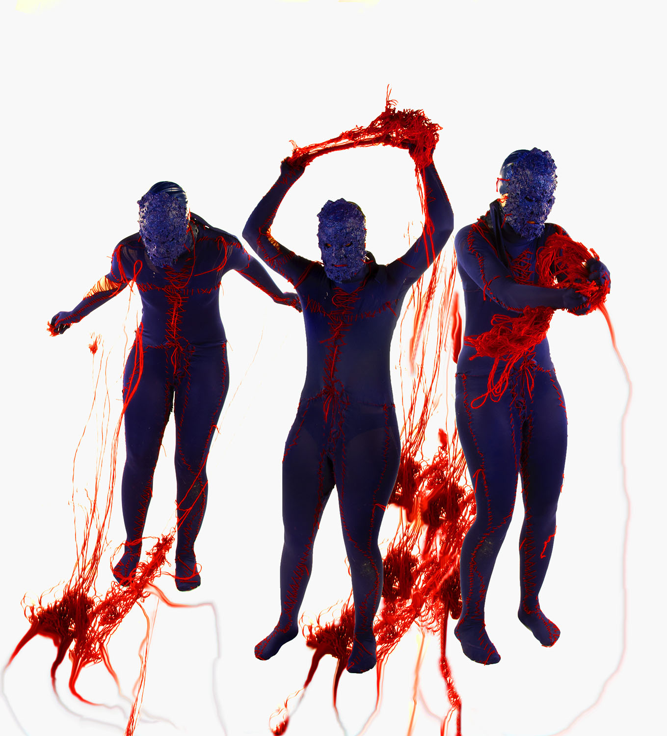 Three human figures covered in purple with textured purple faces, arms to the sides, arms above head, ripping and pulling at bloody red yarn