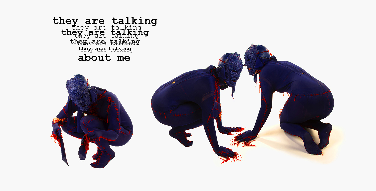 Three crouched figures covered in purple fabric stitched together with blood red yard asking who is talking about me.