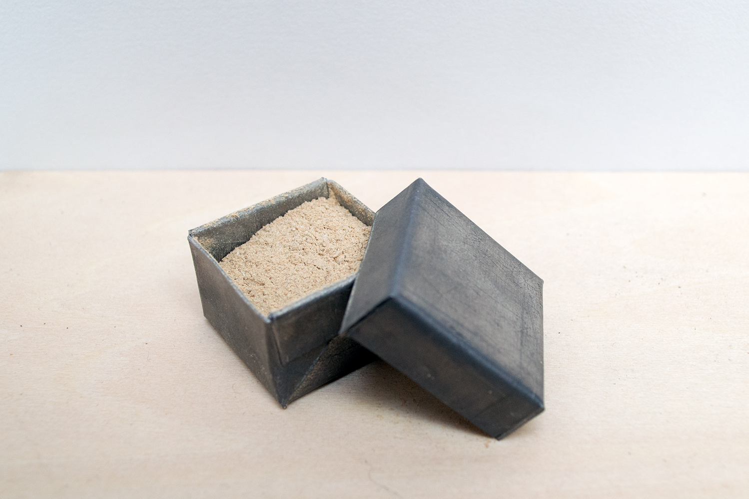 Metal box containing sand