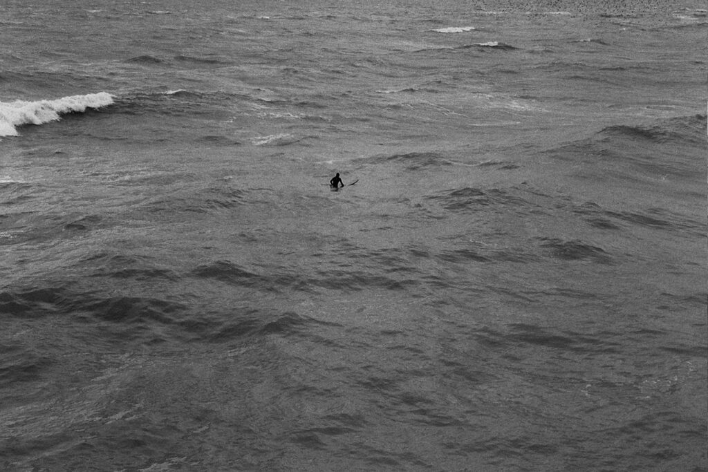Black and white photograph of super in the sea
