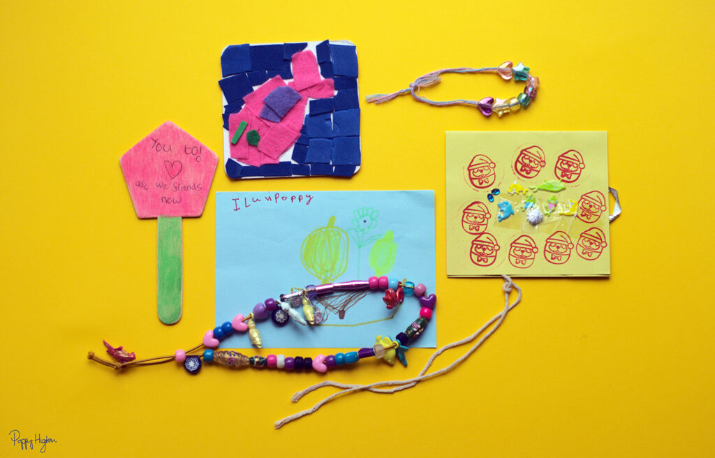 a collection of childhood drawings and jewellery