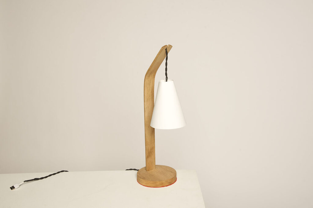 Lamp with wooden base and veneer shade.