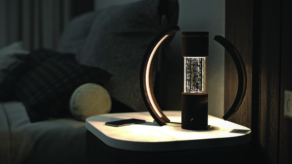 A very stylish photo of a cylinder shaped light that has dark wooden ends with a clear centre with etched lines in it. The light shines through here. 