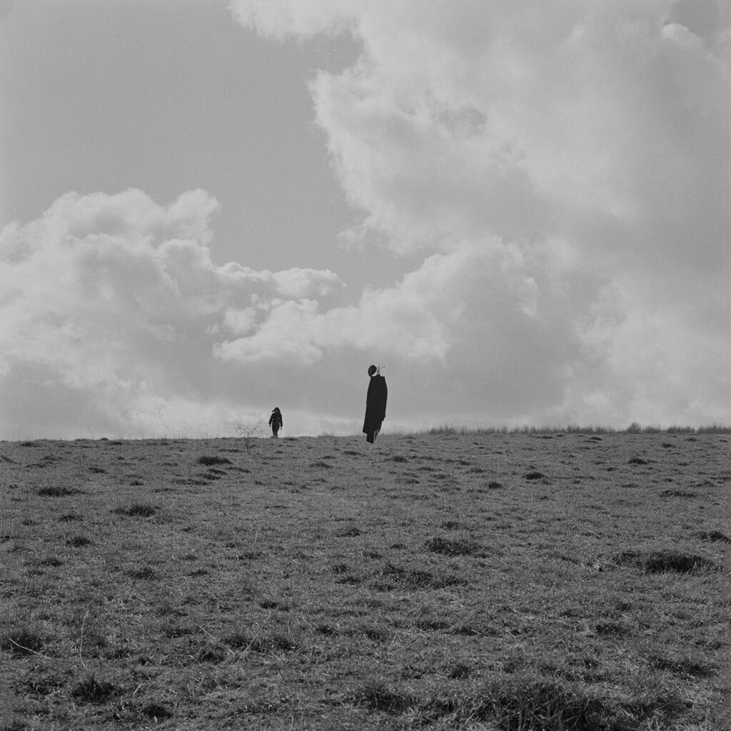 Black and white photograph of figures in field 