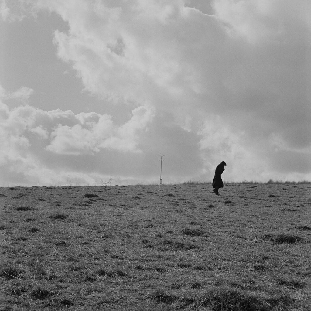 Black and white photograph of figure in field