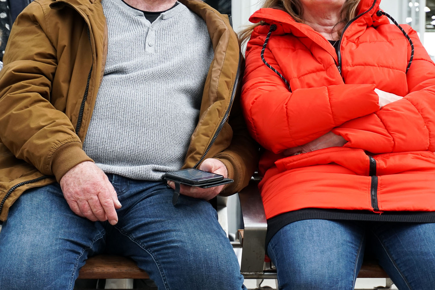 couple on bench with phone
