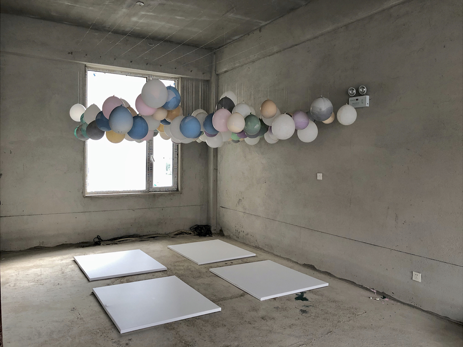 an artists studio - suspended balloons filled with paint